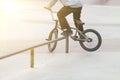 bmx rider in skate park practicing tricks sliding on frame of bike on ramp Royalty Free Stock Photo