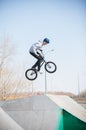 A bmx rider in the skatepark in the air. Daylight