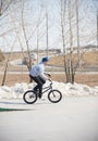 A bmx rider in the skatepark in the air. Early spring