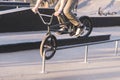 Bmx rider slides along the rails on the front wheel. The teen does tricks on a bmx bike. Bmx Concept