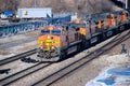 A BNSF diesel locomotive pulls multiple BNSF motive power in various historical color schemes showing years of mergers