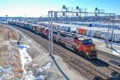 A BNSF diesel locomotive pulls multiple BNSF motive power in various historical color schemes showing years of mergers