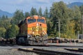 BNSF freiht train passing Skykomish railroad crossing in early fall Royalty Free Stock Photo