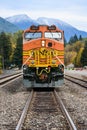 BNSF locomotive stands at Skykomish with first snow on distance mountains