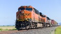 BNSF mixed freight train passing against blue sky