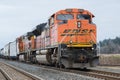 BNSF mixed freight train waits in branded paint scheme