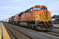 BNSF train with mixed freight load behind three locomotives