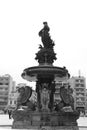 A bnw photo of a fountain at the city of patra