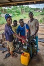 Bo, Sierra Leone - January 19, 2014: Group of unidentified young African mechanics operating diesel generator