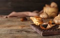 Board with black garlic on wooden table