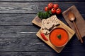 Board with bowl of fresh homemade tomato soup and crispbreads on wooden background, top view Royalty Free Stock Photo