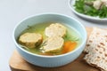 Board with bowl of Jewish matzoh balls soup Royalty Free Stock Photo