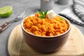 Board with bowl of tasty sweet potato puree Royalty Free Stock Photo