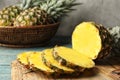 Board with cut fresh juicy pineapple on wooden table Royalty Free Stock Photo