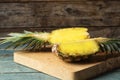 Board with cut fresh juicy pineapple on wooden table Royalty Free Stock Photo