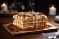 Board with delicious caramel cake on table