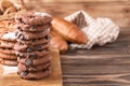 Board with delicious chocolate chip cookies on wooden table Royalty Free Stock Photo