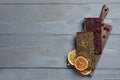 Board and different chocolate bars with freeze dried fruits on grey wooden table, top view. Space for text Royalty Free Stock Photo