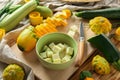 Board with fresh zucchinis on wooden table