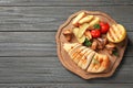 Board with fried chicken breast and garnish on wooden background, top view. Royalty Free Stock Photo