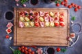 Board full of pinxtos or tapas with jamon, ham and cheese, copyspace Royalty Free Stock Photo