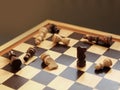 Board game of chess. Wooden chess pieces are lying on a chessboard. Concept logic, strategy, defeat Royalty Free Stock Photo