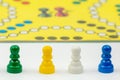 Board game with different colored game pawns on it. Ludo or Sorry board game play figures Royalty Free Stock Photo