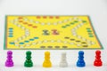 Board game with different colored game pawns on it. Ludo or Sorry board game play figures Royalty Free Stock Photo