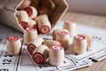 Board game lotto. Cards for the game of lotto on them wooden barrels spilled out of the bag. Wooden background. Group