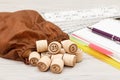 Board game lotto on white desk. Wooden lotto barrels with bag, g Royalty Free Stock Photo