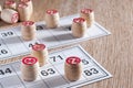 Board game lotto. Wooden lotto barrels and game cards for a game in lotto. Wooden background. Group entertainment, family leisure