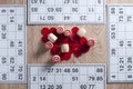 Board game lotto. Wooden barrels and red chips in the center of the table, opposite to four cards. Group entertainment, family