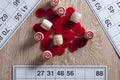 Board game lotto. Wooden barrels and red chips in the center of the table, opposite to three cards. Group entertainment, family