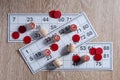 Board game lotto. Wooden lotto barrels, red chips and three game cards for a game in lotto. Wooden background. Group entertainment