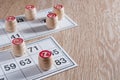 Board game lotto. Wooden lotto barrels and two game cards for a game in lotto. Wooden background. Group entertainment, family