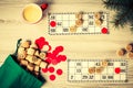 Wooden lotto barrels with bag, game cards, red chips and cup of coffee Royalty Free Stock Photo