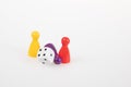Board game pieces and six sided dice on white background Royalty Free Stock Photo