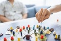 Board game playing concept. People hands hold meeple figures for playing board game on board game field with many figure, dice, Royalty Free Stock Photo