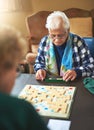 Board game, senior women and nursing home friendship or old people, thinking and play games together in retirement Royalty Free Stock Photo