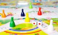 Board games for the home. Yellow, green, blue, red plastic chips and dice on Board games for children . Selective focus Royalty Free Stock Photo