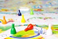 Board games for the home. Yellow, green, blue, red plastic chips and dice on Board games for children . Selective focus Royalty Free Stock Photo