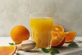 Board with glass of orange juice, oranges and juicer on wooden background Royalty Free Stock Photo