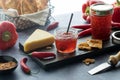 A board with hot pepper jelly served with crackers and cheese, lit from behind. Royalty Free Stock Photo