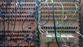 A board with many sockets and connected wires. Sound installation. Sound engineer equipment