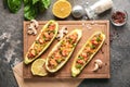 Board with meat stuffed zucchini boats and spices on grunge table Royalty Free Stock Photo