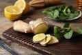 Board with mint and ginger on wooden table. Royalty Free Stock Photo