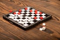 A board for playing checkers with chips on a wooden table, close-up, selective focus Royalty Free Stock Photo