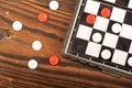 A board for playing checkers with chips on a wooden table, close-up, selective focus Royalty Free Stock Photo