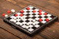 A board for playing checkers with chips on a wooden table, close-up, selective focus Royalty Free Stock Photo