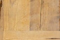 Board with pressed pieces and grain in several directions of pine wood with worn varnish. Royalty Free Stock Photo